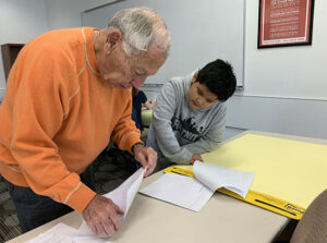 Mickey Klein helping a UTES student