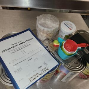 Chef Kim's prep items: large cans of tomatoes and containers of chopped onions and spices.