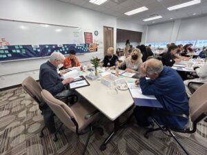 Room photo of individuals working at the joint strategic planning session