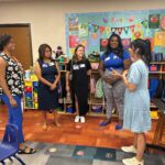 Photo of HEB representatives with Ms. Robinson in the Pre-K room