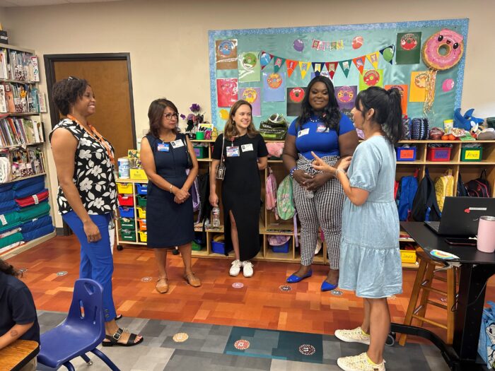 Photo of HEB representatives with Ms. Robinson in the Pre-K room