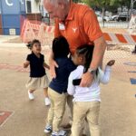 Volunteer Ronnie on the playground with Pre-K students