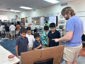 Joshua Otti leading students in a binary number search. 