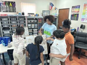 Tayvin Otti leading students in a binary search game.