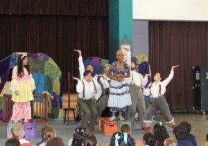 Cast from the play acting out a scene