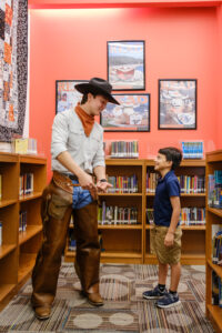 Clayton Bouwhuis and his mentee choose a book to read together.